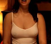 giving massage in a thin braless top