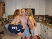 Topless kissing in the kitchen