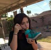 This girl eating spaghetti out of a shoe