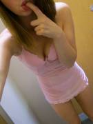 Girl in pink lingerie takes pictures