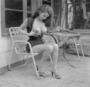 An amateur, posing in someone's backyard patio. 1950s era