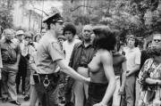 Stripper Candy Love is arrested for going topless in front of City Hall in a one-person protest, New York, June 1975