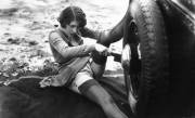 Woman changing tire -1920s