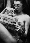 Burlesque dancer catching up with the days events. 1950s