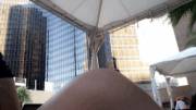 Hotel pool surrounded by people and office buildings. Quick [f]lash in my swimsuit.