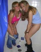 2 girls peeing in the shower.