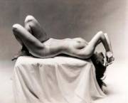 "Nude Laying on Pedestal" photographed by Andre de Dienes (1955)