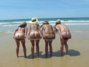 Tan-lined babes mooning on the beach