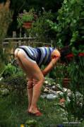 bent over in the garden and pees