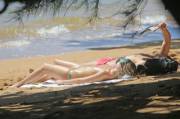Margot Robbie tanning topless on the beach