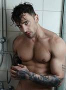 Can someone help me identify this hot ripped male model in a shower photoshoot with a "Boy's Dont Cry Tattoo" in his left arm.