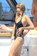 Paris Hilton pokies in a black swimsuit