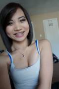 Asian braceface smiles and sucks
