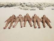 Five naked sunbathers