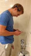 Multi-tasking guy at a urinal