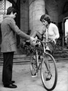 Gentleman helps lady with her bike.
