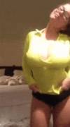 Lifting her yellow long-sleeved top [gif]