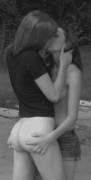 Topless girl kissing bottomless girl