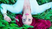 Caity Lotz lays on the grass