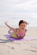 Chyler doing yoga at the beach