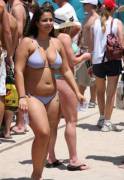 Chubby girl shows off her tiny bikini on a crowded beach