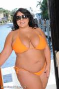 Jane Kush in and out of an orange bikini