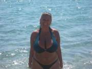 Tan blonde shows off her massive tits at the beach