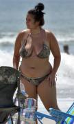 Growing chubby girl wearing a camo bikini