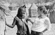 Western journalist and African tribeswomen grope each other