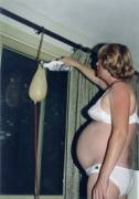 Very pregnant Emily swells herself even bigger with a gallon of enema