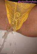 Squirting through her yellow panties