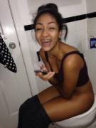 Latina girl caught sitting on the toilet