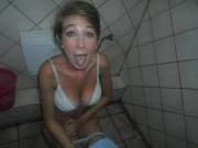 Girl sticking her tongue out on the potty