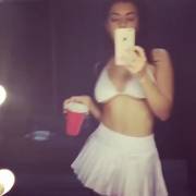 Charli XCX dancing and giving us a peek under her short skirt