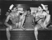 Stripped-down sailors sitting at the bar