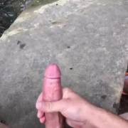 Cumming on rocks at the river