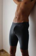 Model boy S. [20m] in a pair of black compression shorts