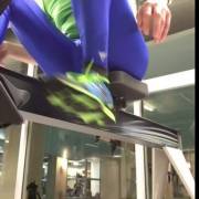 On the rowing machine in blue tights