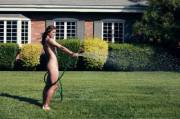 Soccer player Hope Solo watering the lawn