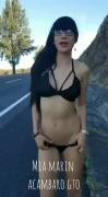 Girl stripping next to a road