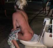 Blonde woman with big tits impatiently go to the toilet in the middle of the street sitting on the toilet [pic]