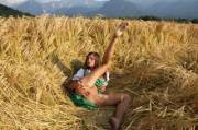 Caprice in a dirndl spreading her legs in a field