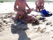 Buddies taking turns to fuck her in the sand
