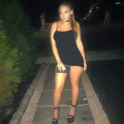 Sexy blonde in tiny black dress and heels