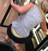 Bright green lace thong on blonde in the grocery store
