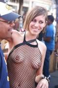 If her top was more opaque then you wouldn't see her nipple piercings. This is a very logical fashion choice.