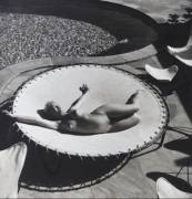 Marilyn Monroe lying naked on a trampoline, 1953.
