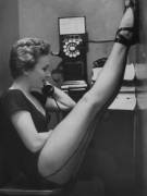 Photographer: Gordon Parks Dancer Mary Ellen Terry Talking with Her Legs Up in Telephone Booth, 1952