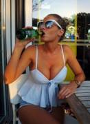 A bountiful young lass enjoying a beverage...