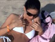 Cute beach girl gets embarrassed after flashing her boobs [gif]